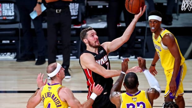 Miami Heat guard Goran Dragic drives against Los Angeles Lakers guard Alex Caruso and forward LeBron James during the 2020 NBA Finals at AdventHealth Arena.